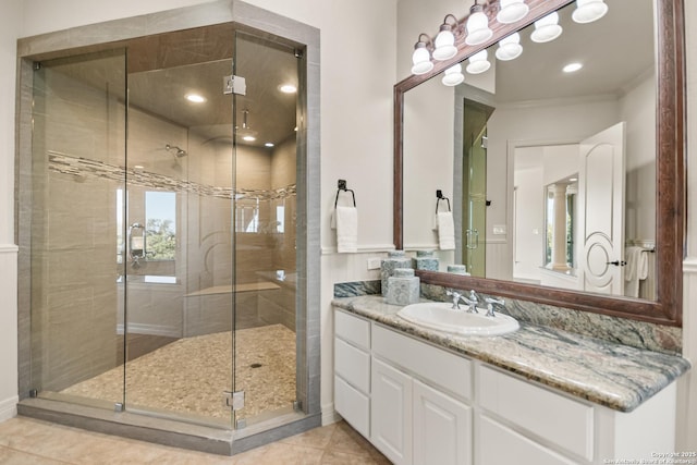 bathroom with ornamental molding, vanity, tile patterned floors, and a shower with shower door