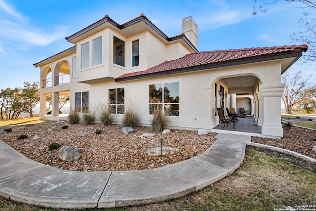 exterior space featuring a patio and a balcony