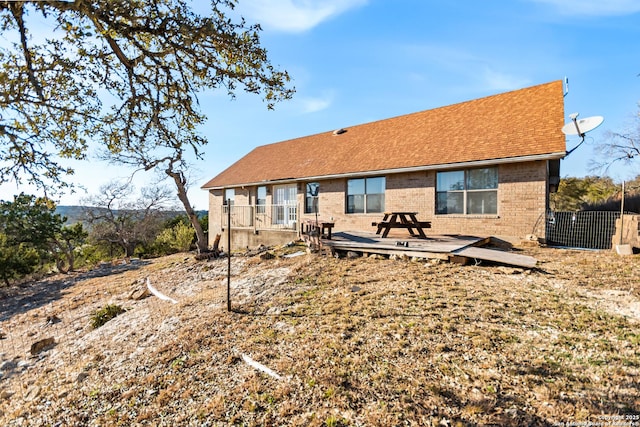 rear view of house featuring a deck