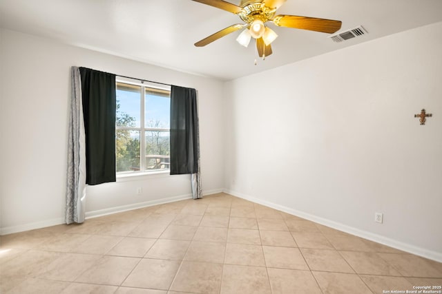 tiled empty room featuring ceiling fan