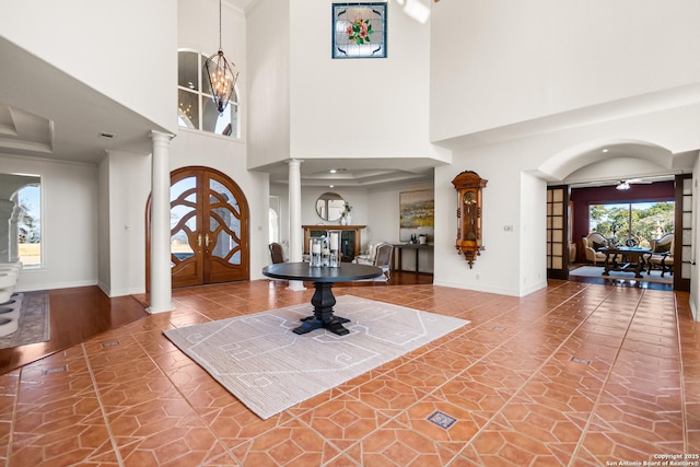 entrance foyer featuring a high ceiling and ornate columns