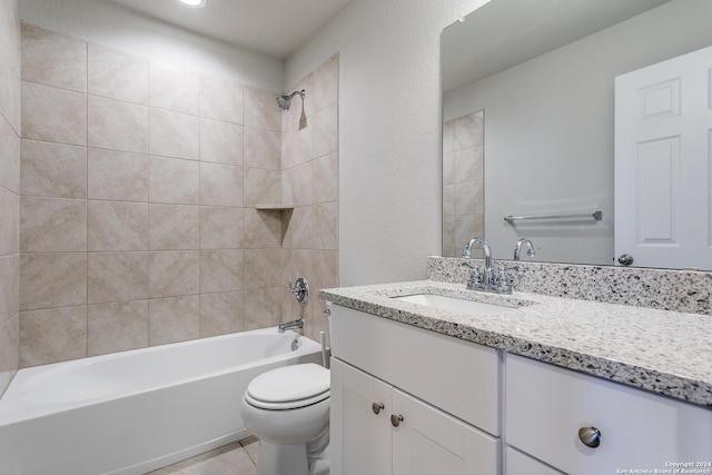 full bathroom with tiled shower / bath combo, vanity, tile patterned flooring, and toilet