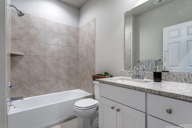 full bathroom featuring vanity, tiled shower / bath combo, tile patterned floors, and toilet