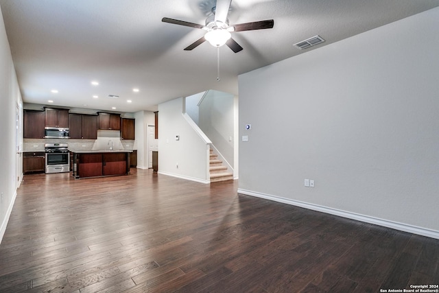 living room with dark hardwood / wood-style flooring, sink, and ceiling fan