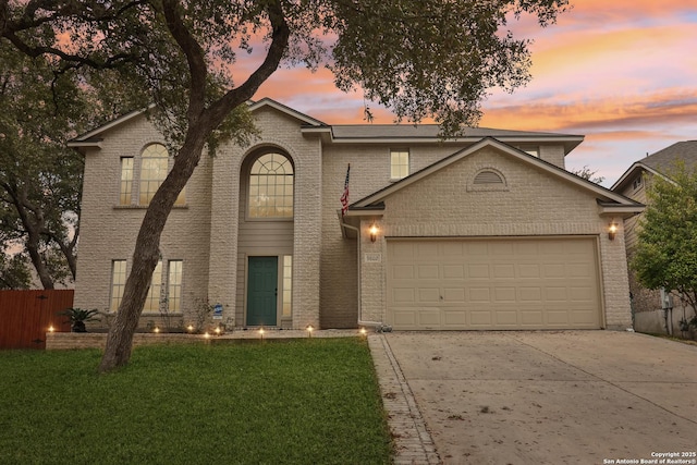 front of property featuring a yard and a garage