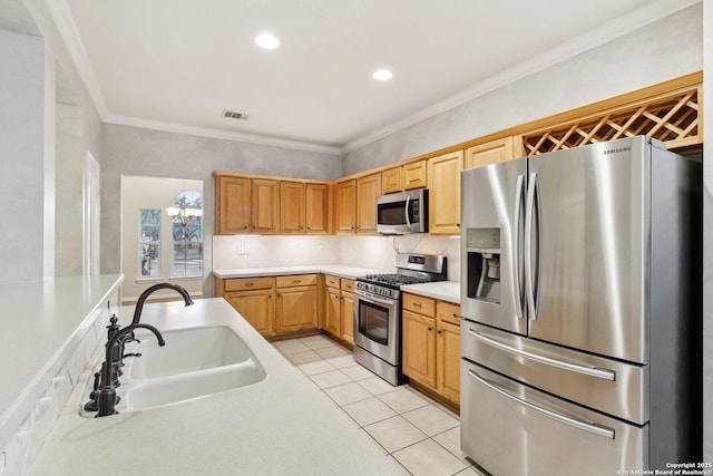 kitchen with sink, crown molding, appliances with stainless steel finishes, light tile patterned flooring, and decorative backsplash