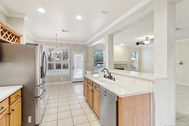 kitchen featuring stainless steel appliances, ornamental molding, sink, and pendant lighting