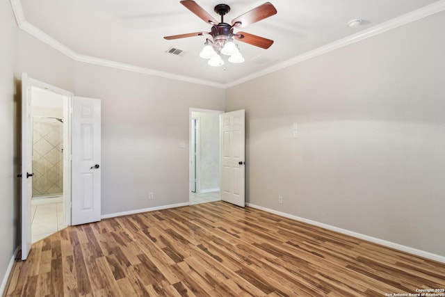 unfurnished bedroom featuring wood-type flooring, ornamental molding, ceiling fan, and ensuite bathroom