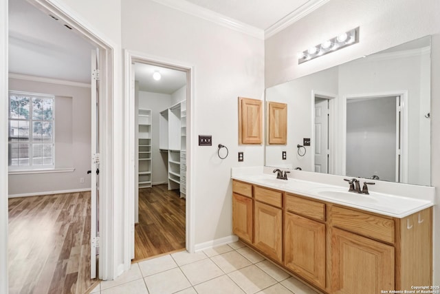 bathroom with crown molding, vanity, and tile patterned flooring