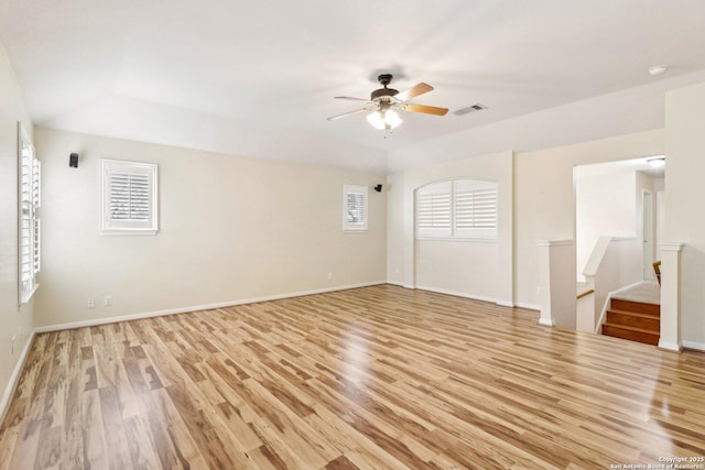 empty room with ceiling fan and light hardwood / wood-style flooring