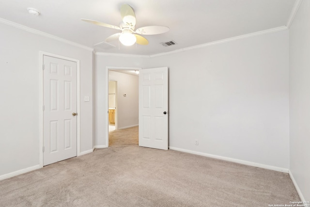 unfurnished room featuring crown molding, light carpet, and ceiling fan