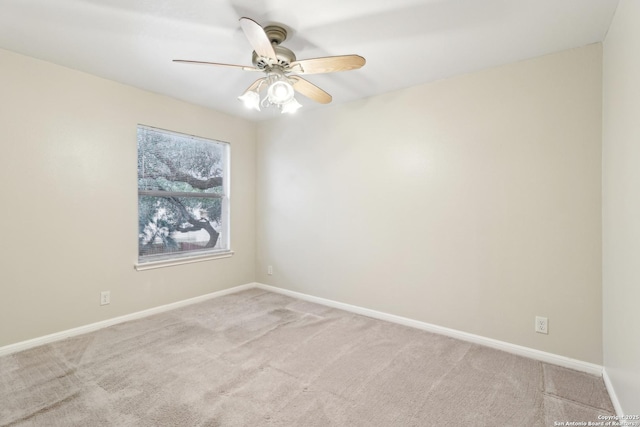 carpeted empty room featuring ceiling fan