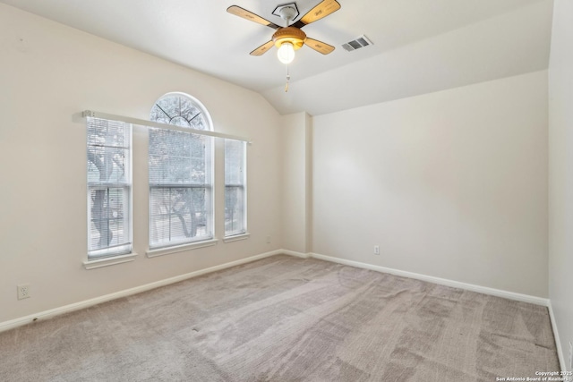 empty room featuring light carpet, lofted ceiling, and ceiling fan