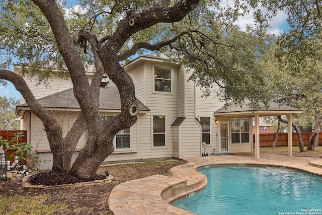 back of house featuring a fenced in pool and a patio area