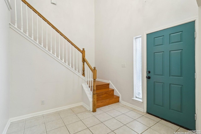 tiled entrance foyer featuring a high ceiling