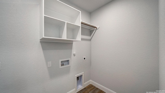 2606 Vistablue Ln, San Antonio, TX 78245 - clothes washing area with electric dryer hookup, dark wood-type flooring, baseboards, hookup for a washing machine, and hookup for a gas dryer