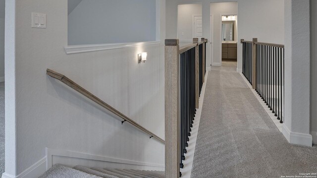 2606 Vistablue Ln, San Antonio, TX 78245 - hallway featuring light carpet, an upstairs landing, and baseboards