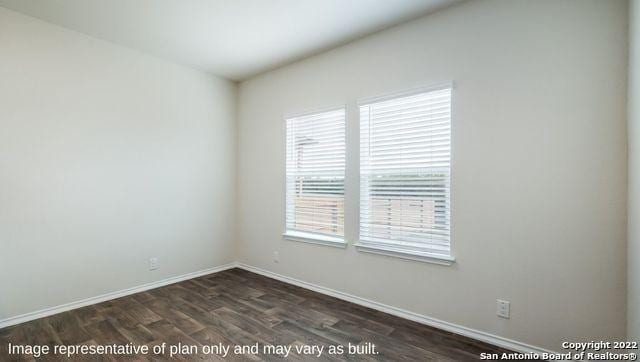 spare room with dark hardwood / wood-style floors