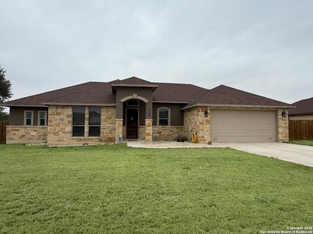 view of front of home featuring a garage and a front lawn