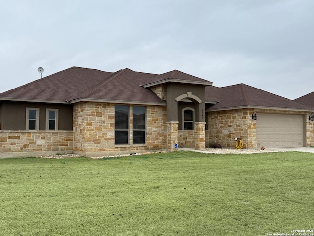 prairie-style house featuring a garage and a front yard