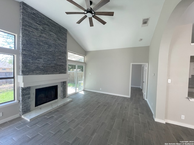 unfurnished living room with ceiling fan, high vaulted ceiling, and a fireplace