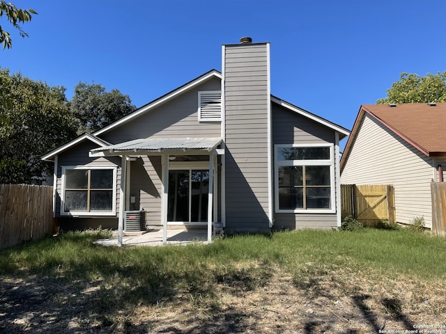 rear view of house featuring cooling unit and a patio