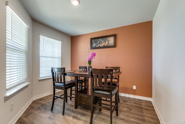 dining area with dark wood-type flooring