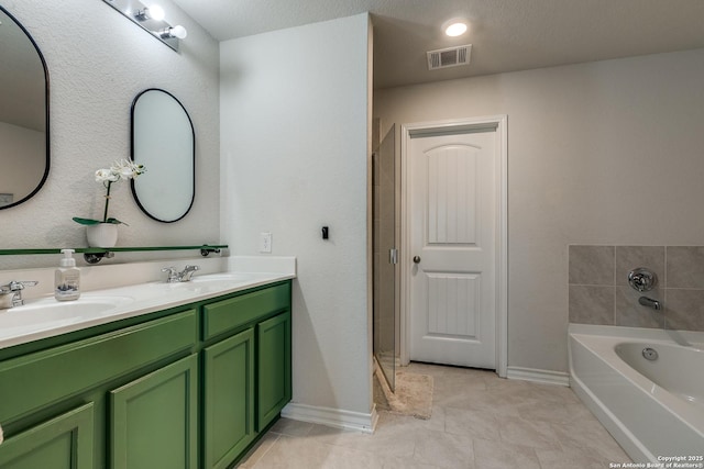 bathroom with vanity, tile patterned flooring, and a tub