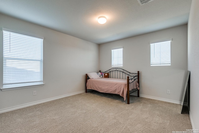 bedroom with light colored carpet