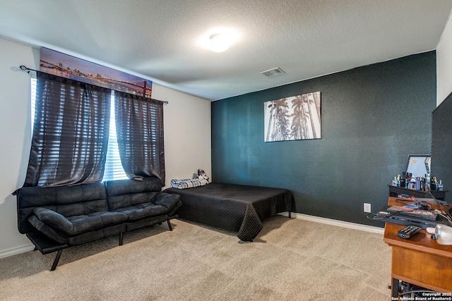 bedroom featuring carpet flooring and a textured ceiling