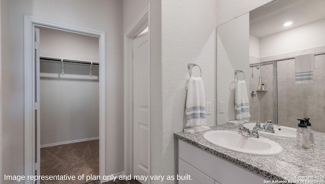 bathroom with an enclosed shower and vanity