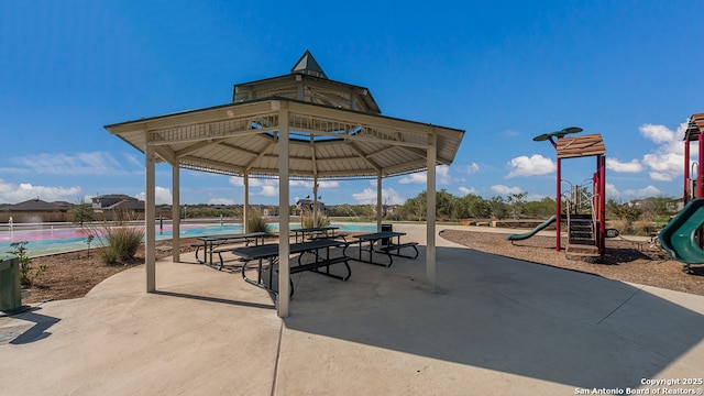 view of patio / terrace with a gazebo and a playground