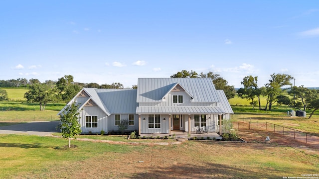 modern farmhouse featuring a front lawn and covered porch