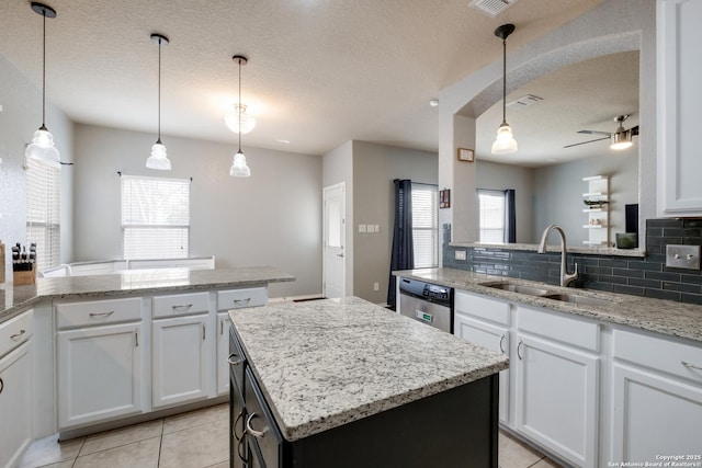 kitchen featuring white cabinetry, sink, a center island, and dishwasher