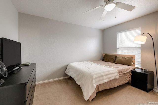 bedroom featuring light colored carpet and ceiling fan