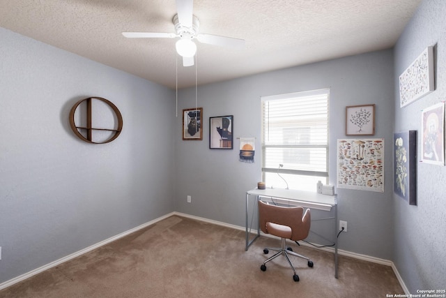 carpeted office with ceiling fan and a textured ceiling