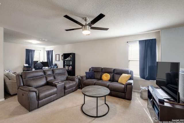 carpeted living room with a textured ceiling and ceiling fan