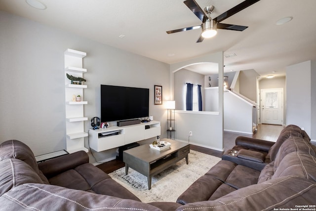 living room featuring wood-type flooring and ceiling fan