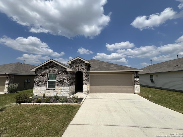 view of front of home with a garage and a front lawn