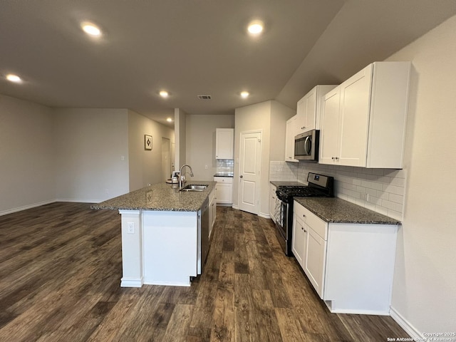 kitchen featuring sink, white cabinetry, dark hardwood / wood-style flooring, an island with sink, and stainless steel appliances