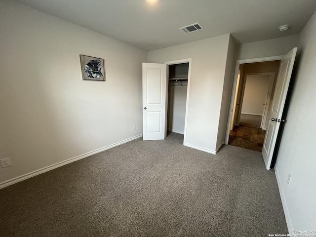 unfurnished bedroom with carpet and a closet