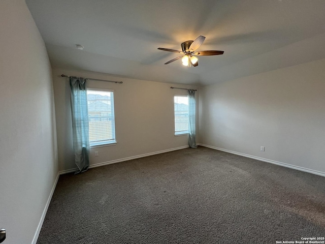 carpeted spare room featuring ceiling fan