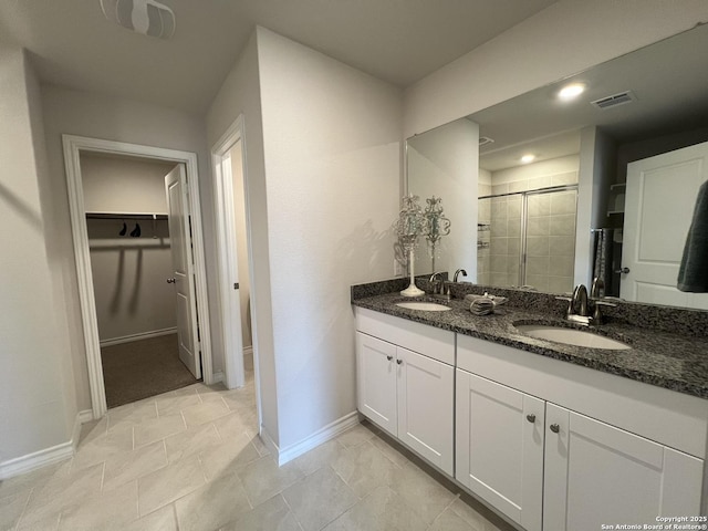 bathroom with vanity and a shower with shower door