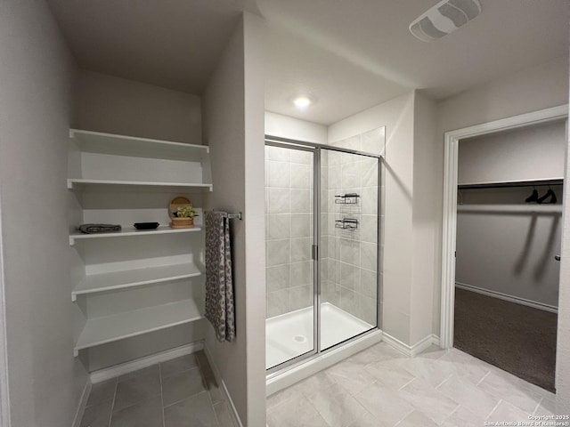 bathroom with tile patterned floors and walk in shower