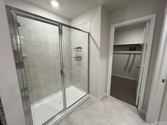 bathroom featuring a shower with door