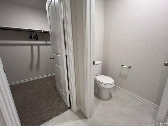 bathroom featuring tile patterned floors and toilet