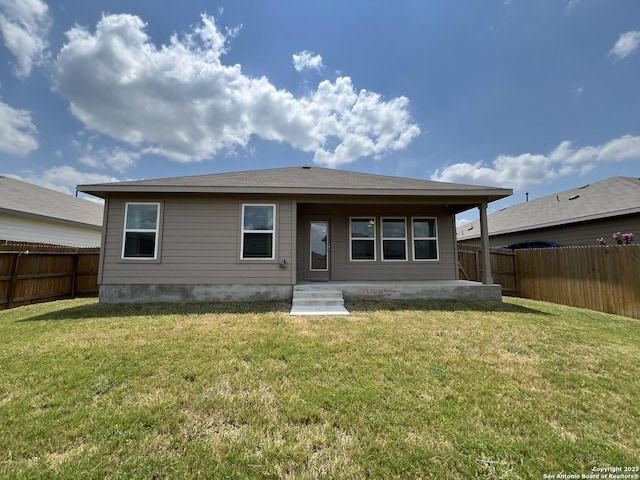 rear view of house with a yard