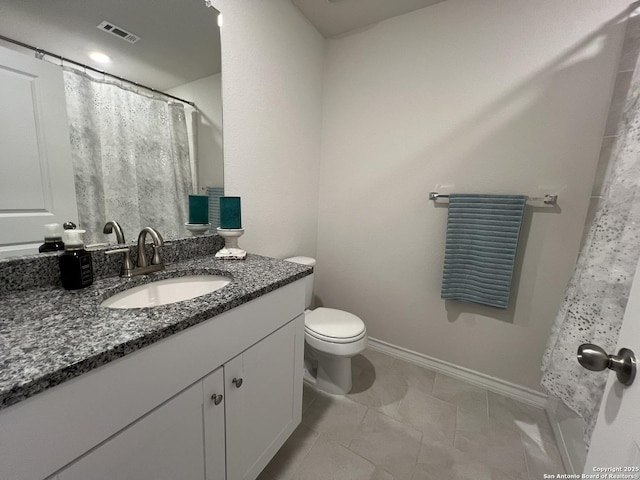 bathroom featuring vanity, tile patterned flooring, and toilet