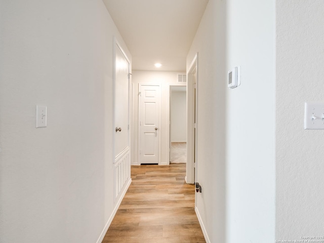 corridor with light wood-type flooring