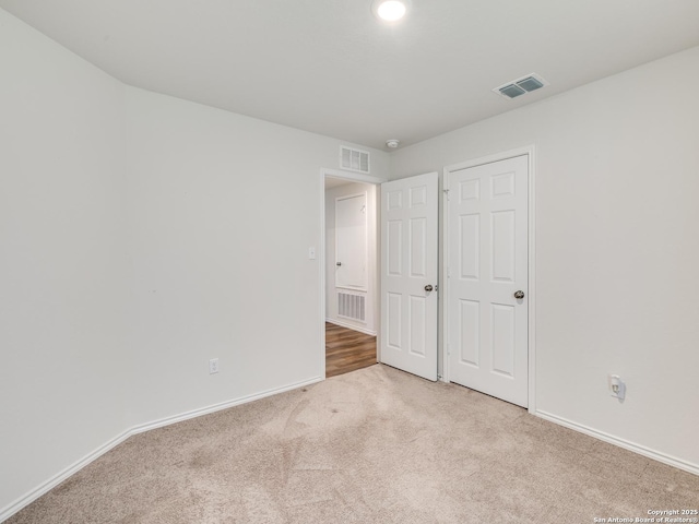 unfurnished bedroom with light colored carpet